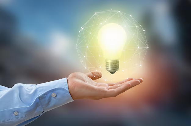 A hand holding a glowing lightbulb surrounded by a network of light